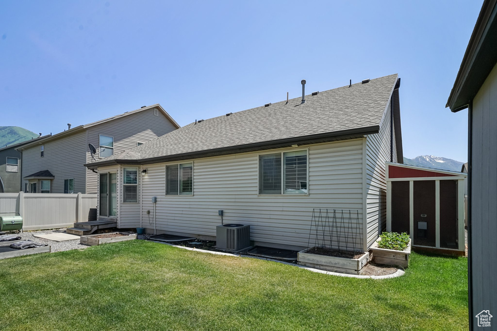 Back of property featuring roof with shingles