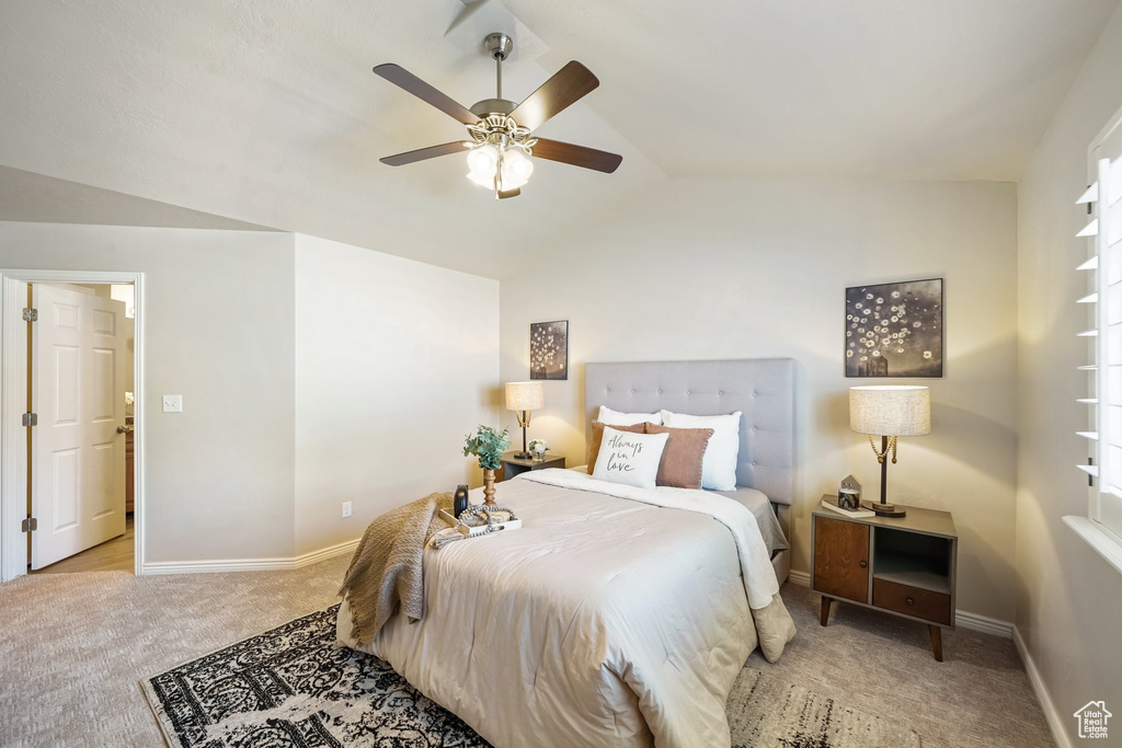 Bedroom featuring carpet floors, lofted ceiling, and a ceiling fan