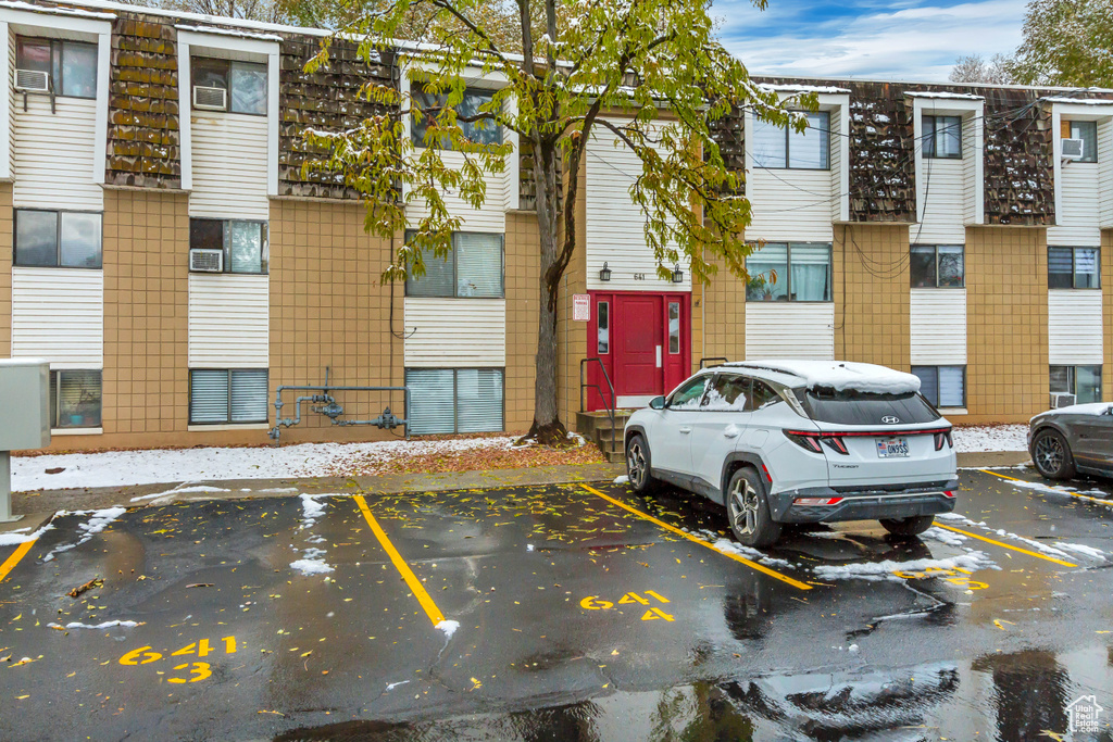 View of building exterior featuring uncovered parking