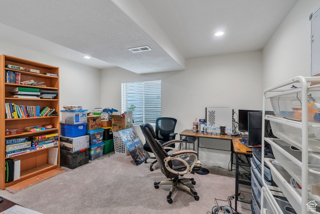 Home office with carpet floors and recessed lighting