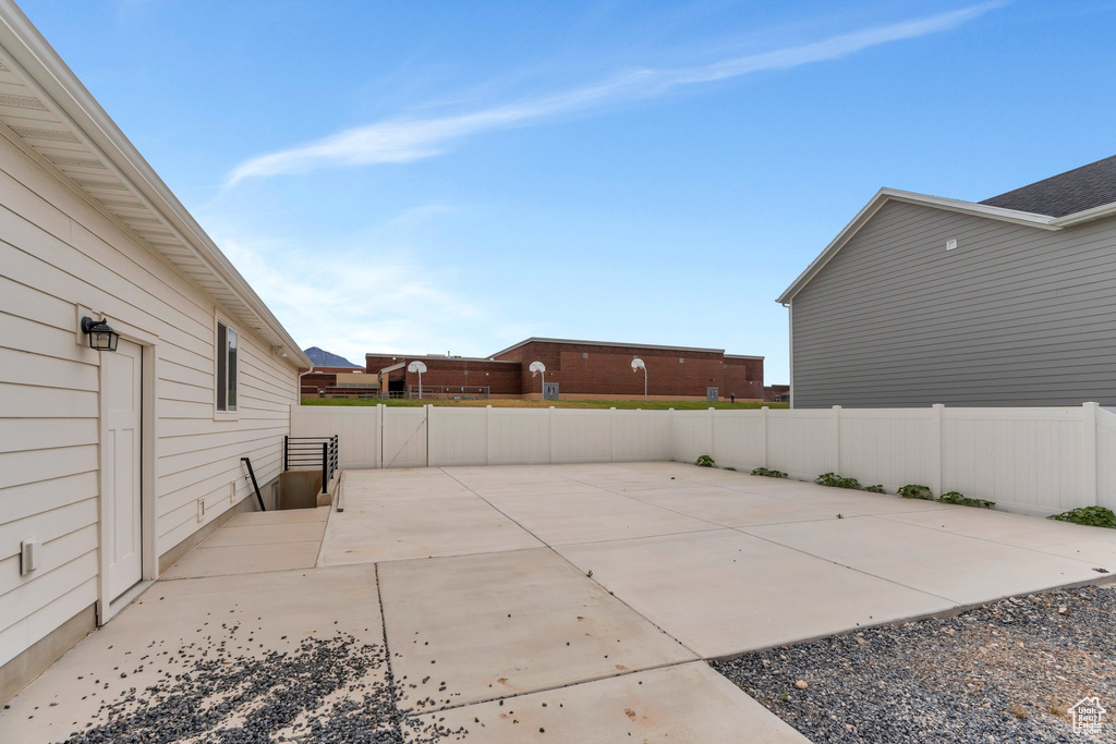 Fenced backyard with a patio