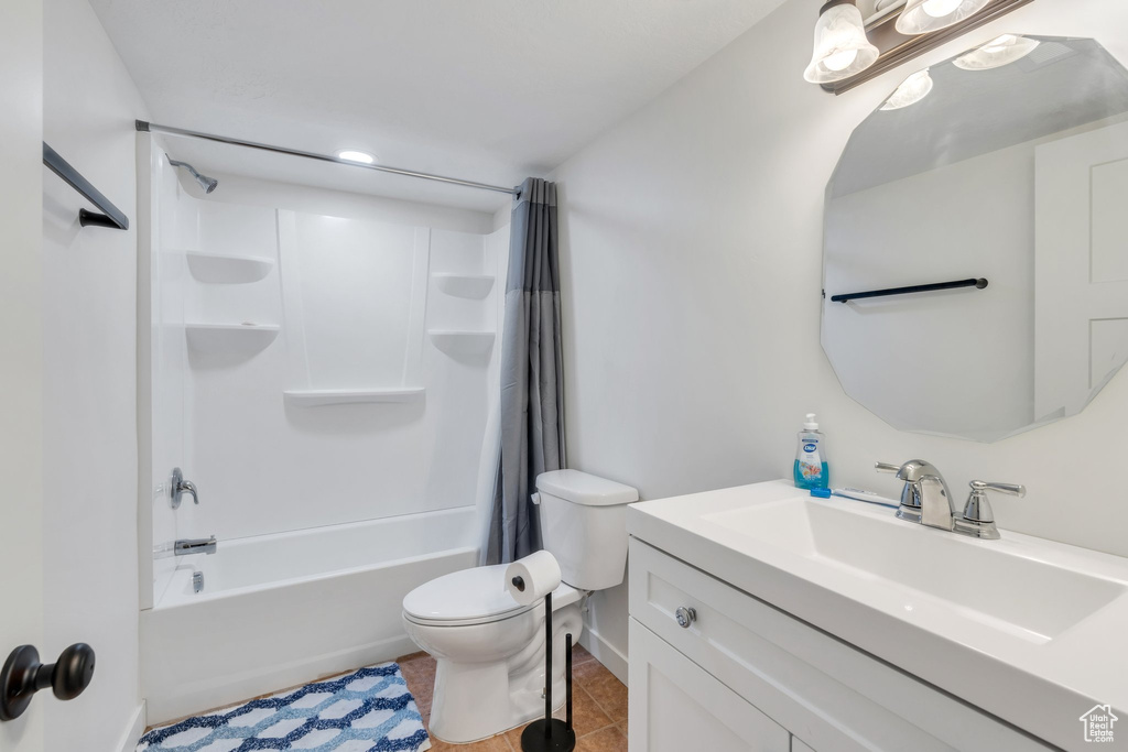 Full bathroom with vanity, tile patterned flooring, and shower / tub combo with curtain