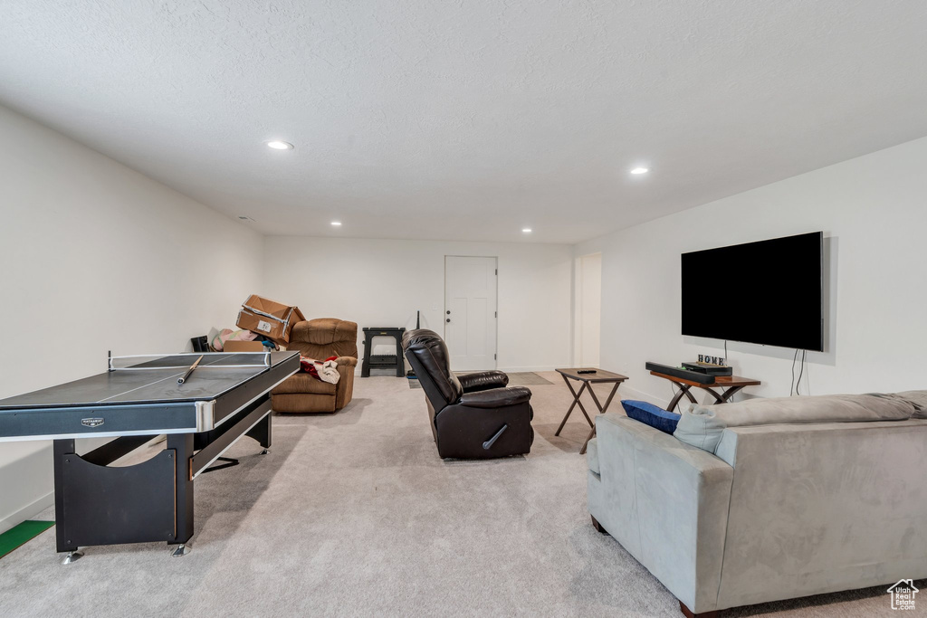 Carpeted living area featuring recessed lighting