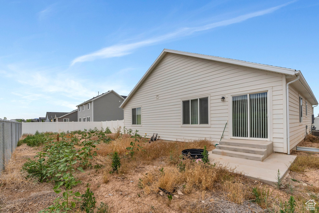 Rear view of property featuring entry steps