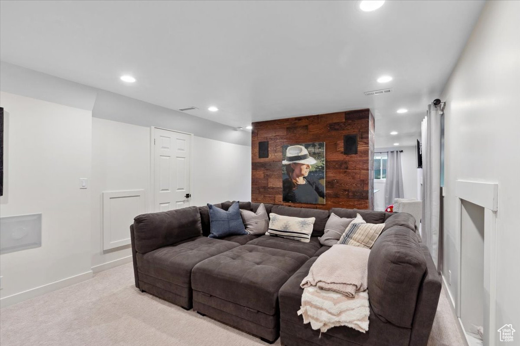 Home theater room with light carpet and recessed lighting