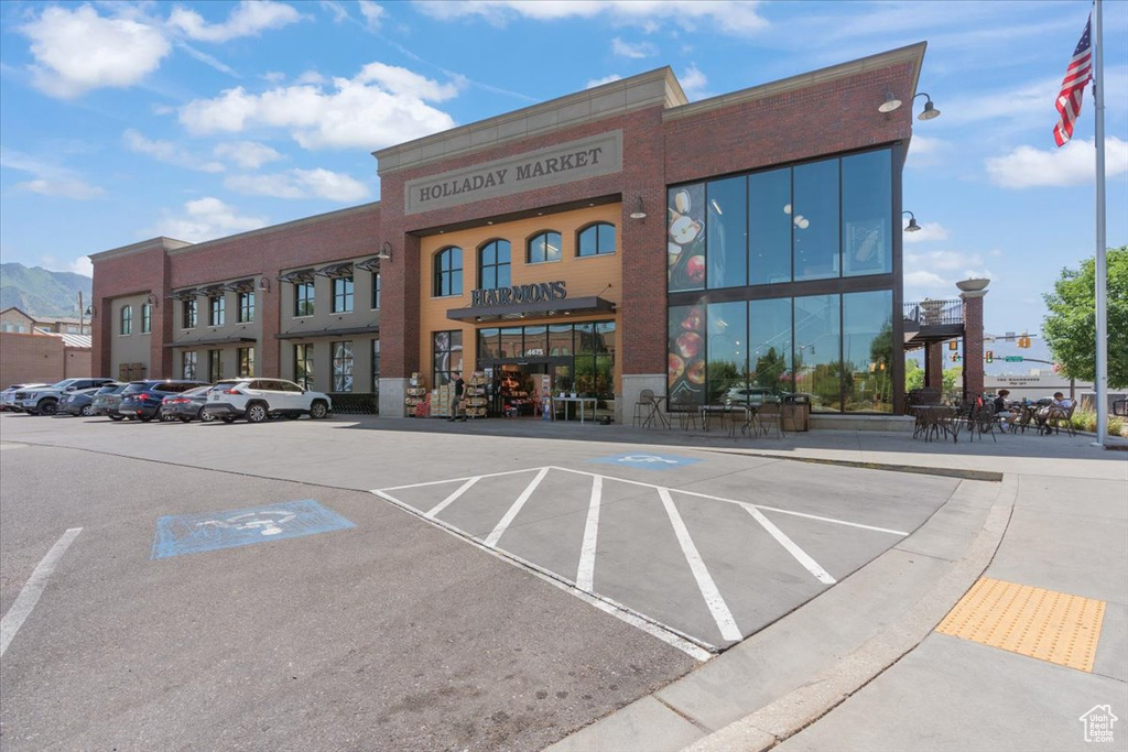 View of commercial property with uncovered parking