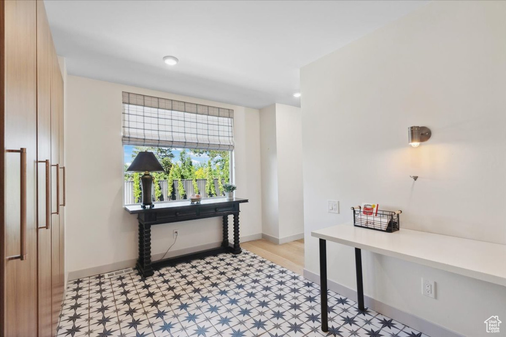 Home office with light flooring and baseboards
