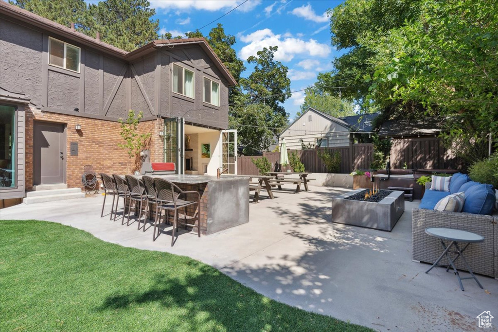 View of patio / terrace with an outdoor living space with a fire pit and entry steps