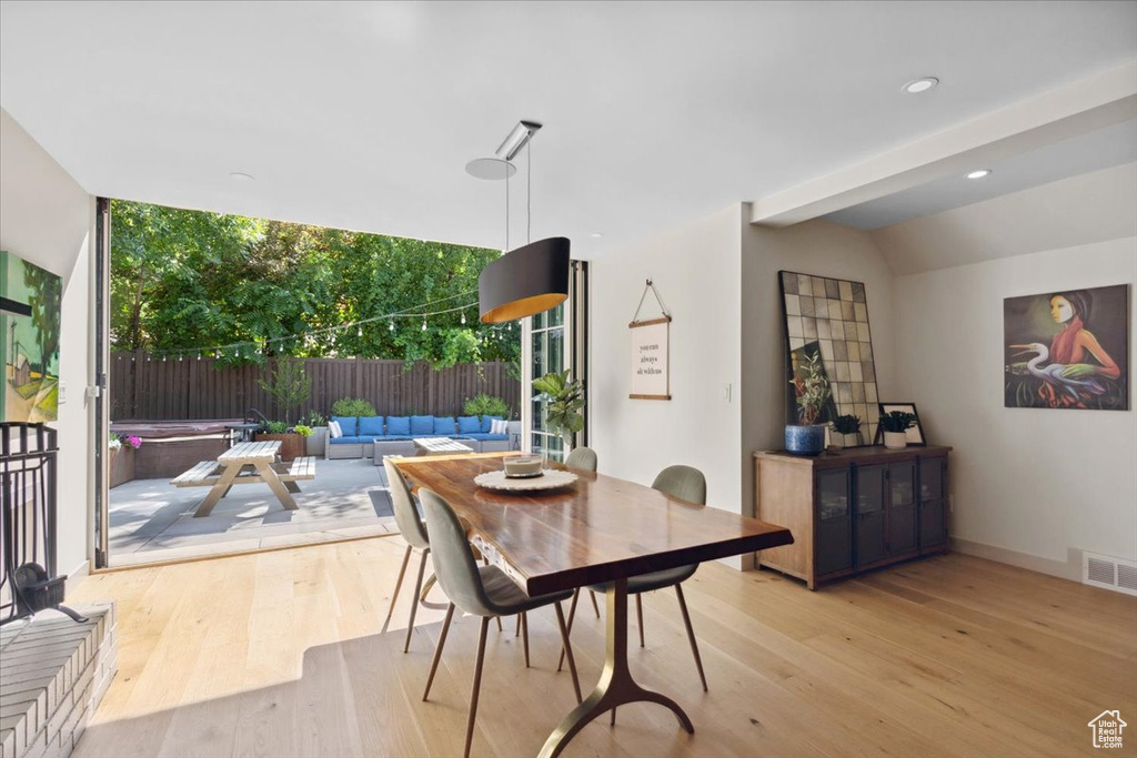 Dining room with wood finished floors and floor to ceiling windows
