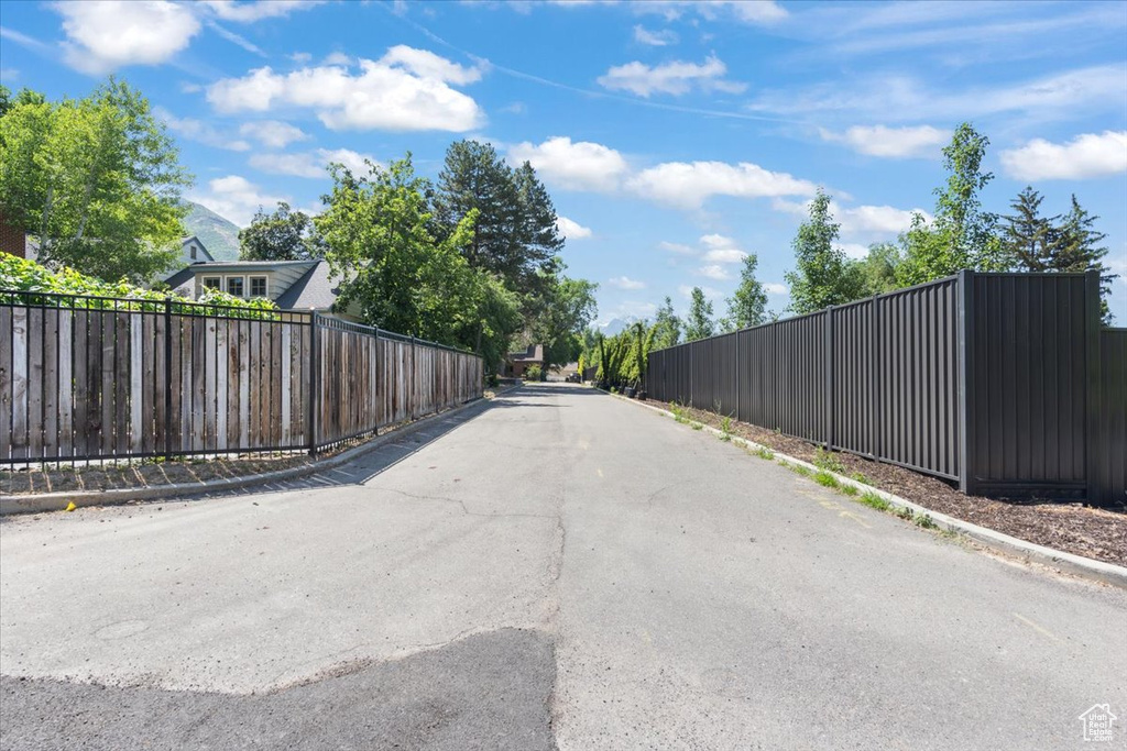 View of asphalt road with curbs