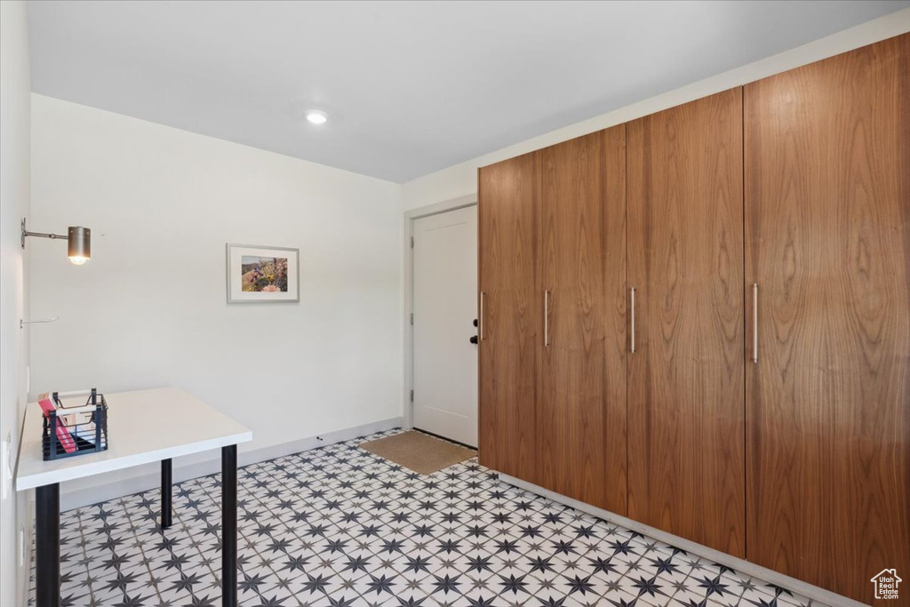 Foyer entrance featuring light flooring and baseboards