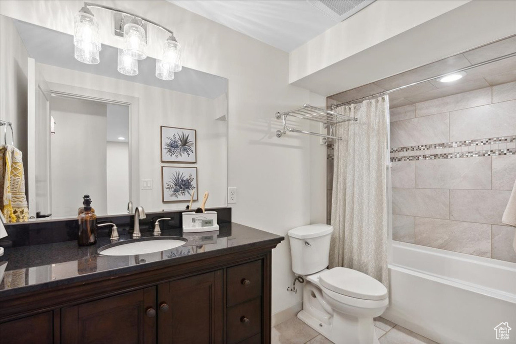 Bathroom featuring vanity, tile patterned flooring, and shower / bath combination with curtain
