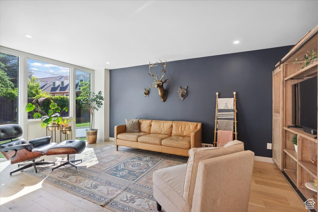 Living room featuring light wood finished floors and recessed lighting
