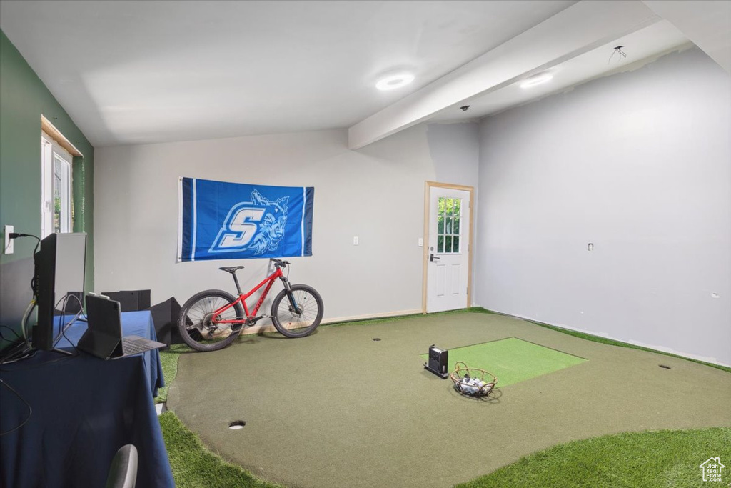 Rec room featuring carpet flooring, lofted ceiling, and golf simulator