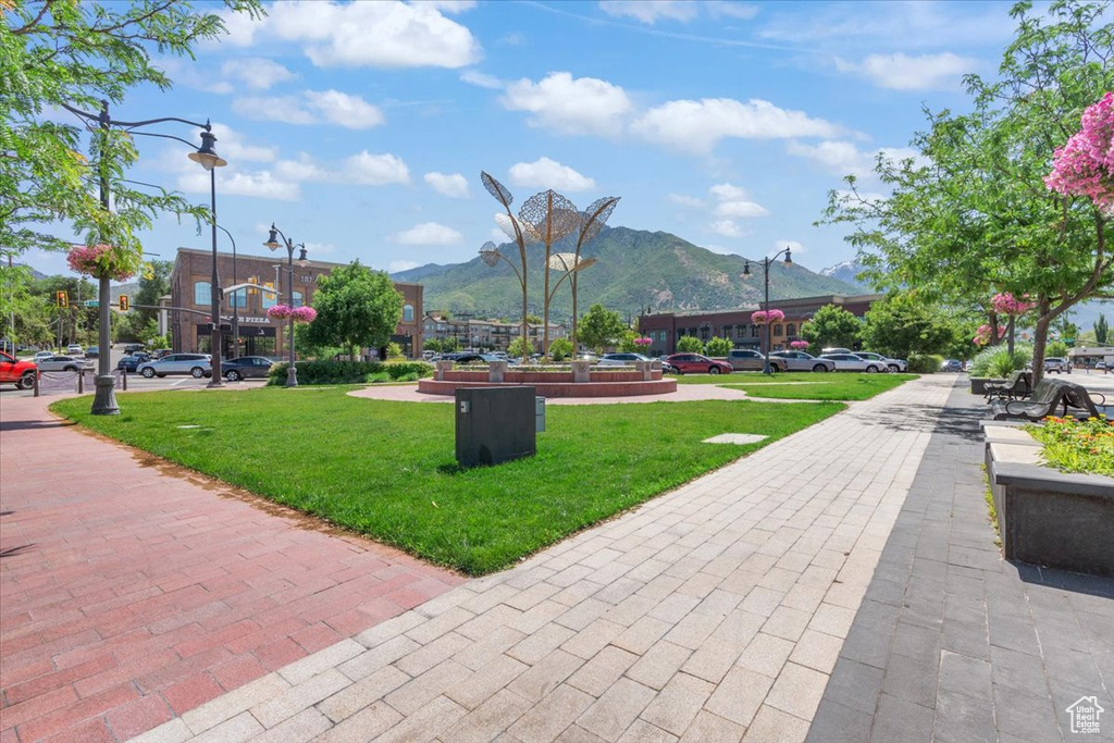 View of home's community with a mountain view and a lawn