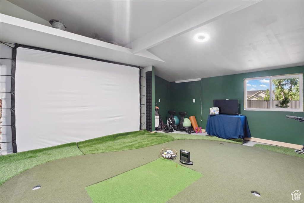 Playroom featuring carpet floors and golf simulator