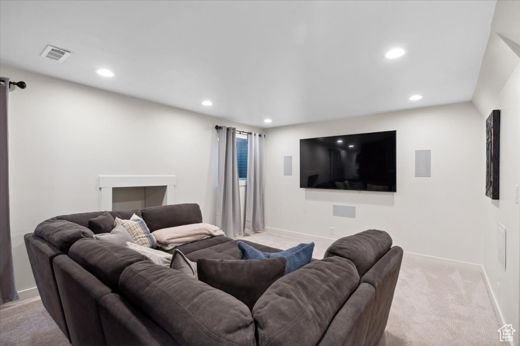Carpeted cinema room with recessed lighting and baseboards