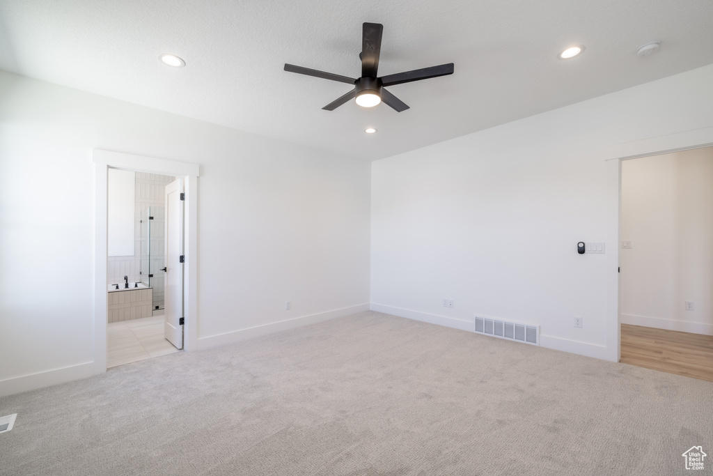 Empty room featuring a ceiling fan, light colored carpet, recessed lighting, and a smoke detector