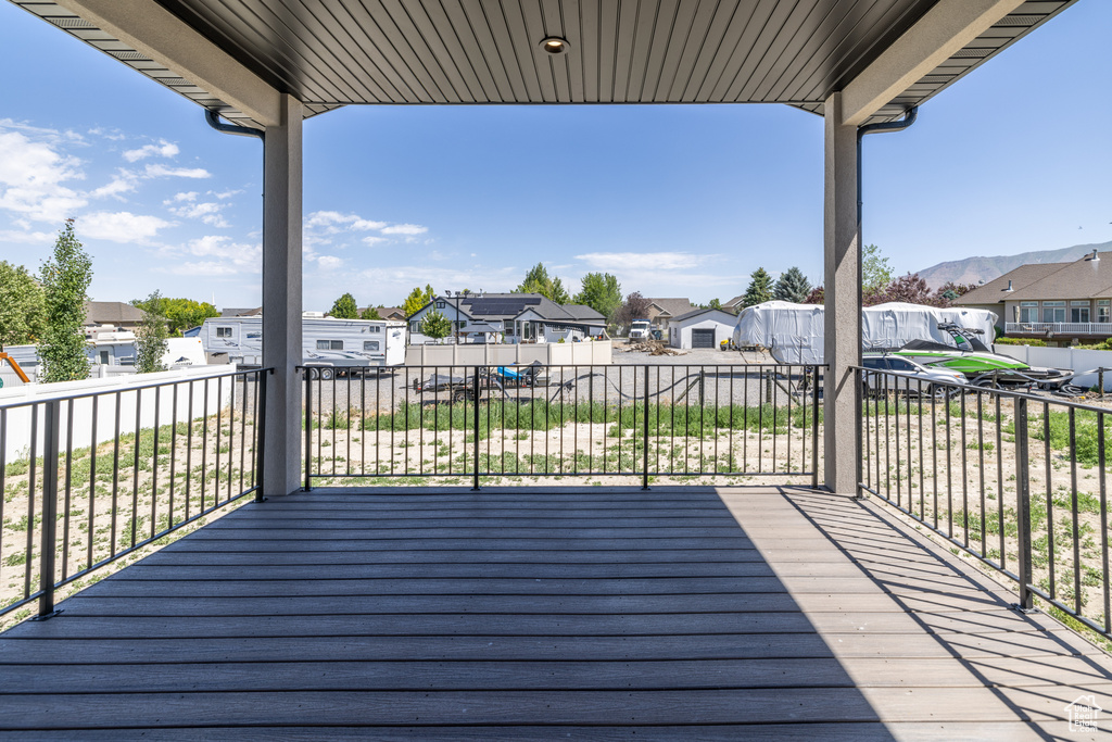 Deck with a residential view and a mountain view