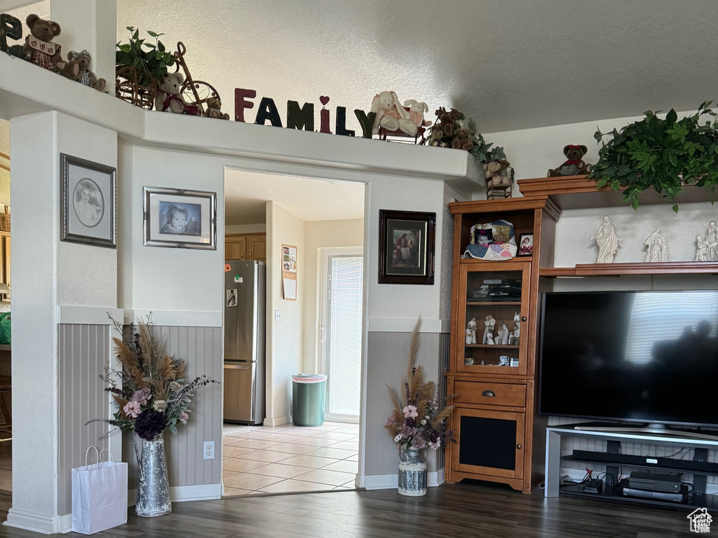 Living room featuring wood finished floors and a wainscoted wall