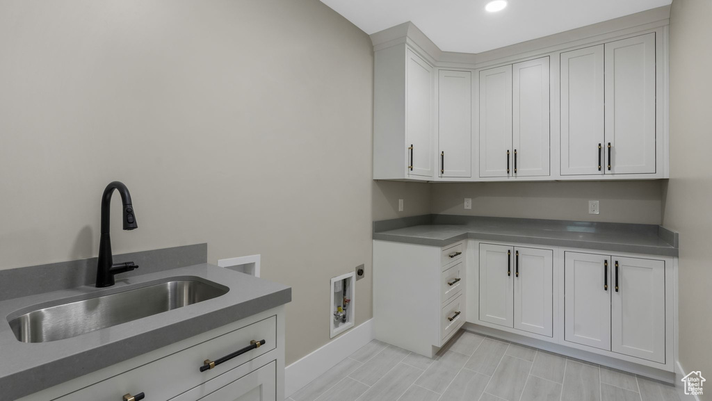Laundry room featuring hookup for a washing machine, cabinet space, hookup for an electric dryer, and recessed lighting