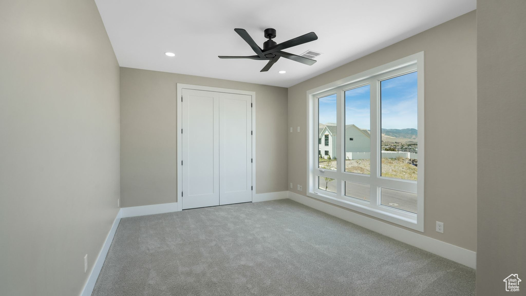 Unfurnished bedroom with carpet flooring, recessed lighting, a closet, and a ceiling fan
