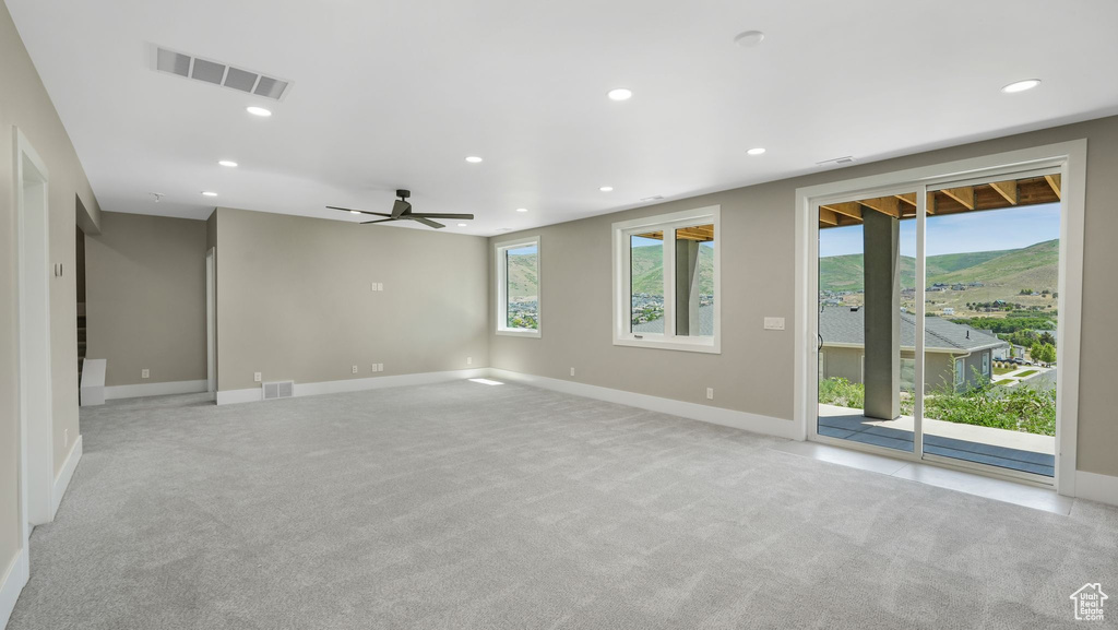 Spare room with light colored carpet, recessed lighting, and ceiling fan