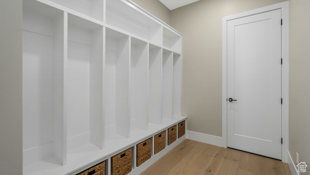 Mudroom with light wood-style floors and baseboards