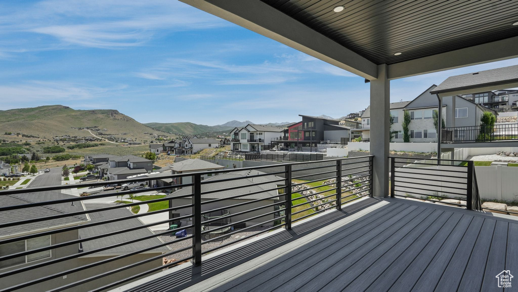Wooden deck featuring a residential view and a mountain view