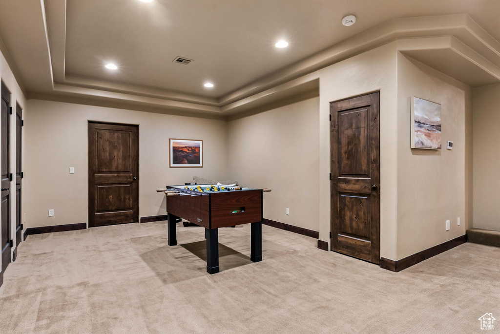 Game room with light carpet, recessed lighting, and a tray ceiling