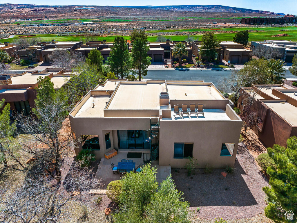 Aerial view of property and surrounding area with a mountain backdrop