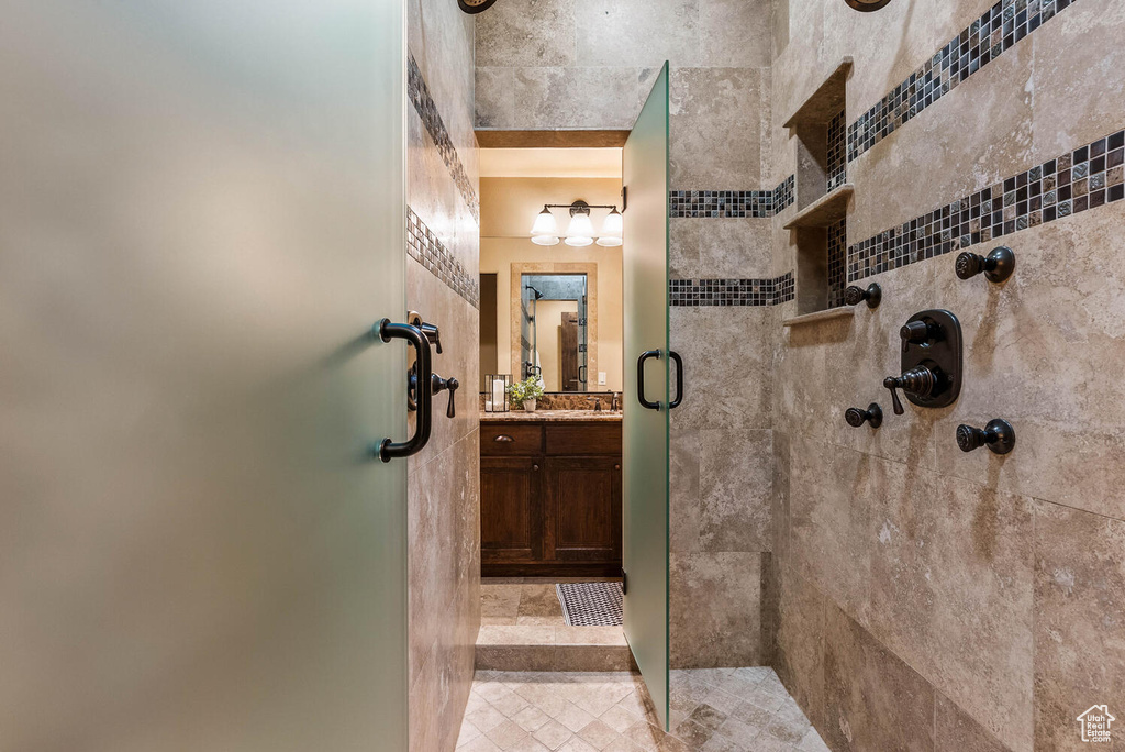 Bathroom featuring a shower stall and vanity