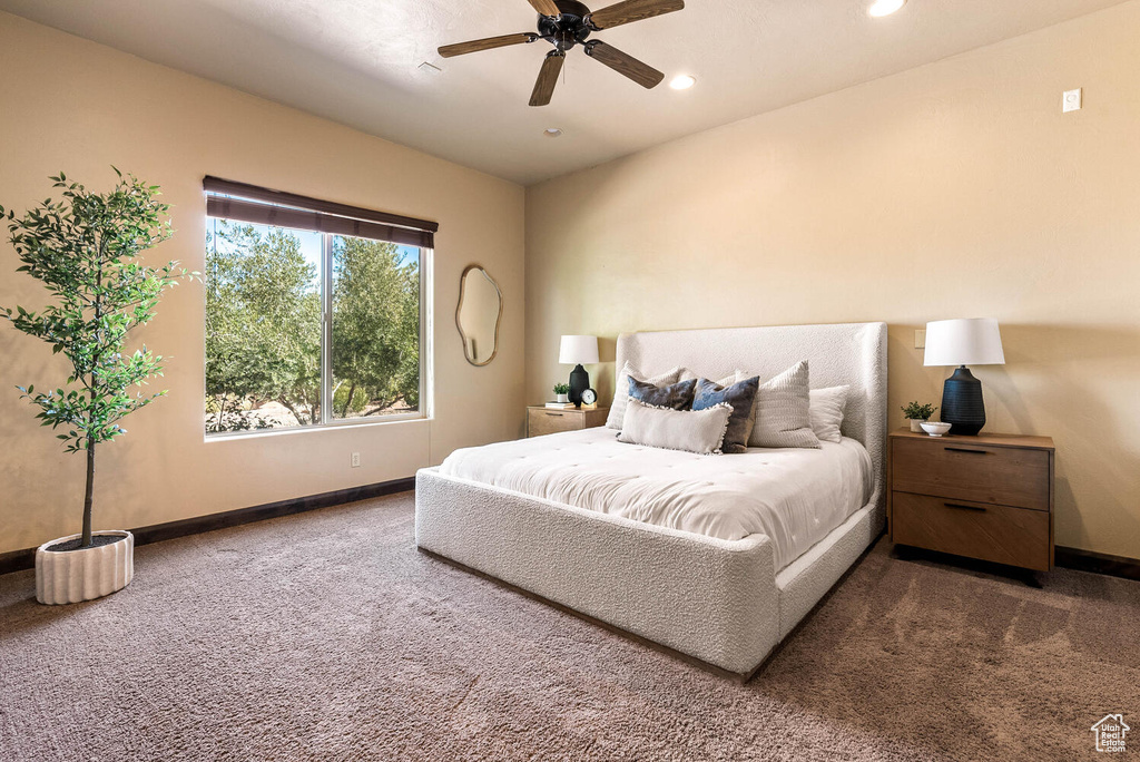 Carpeted bedroom with recessed lighting and a ceiling fan