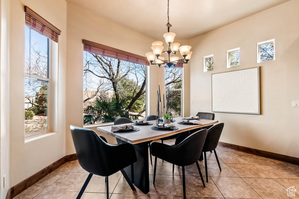 Dining room featuring a chandelier and light tile patterned flooring