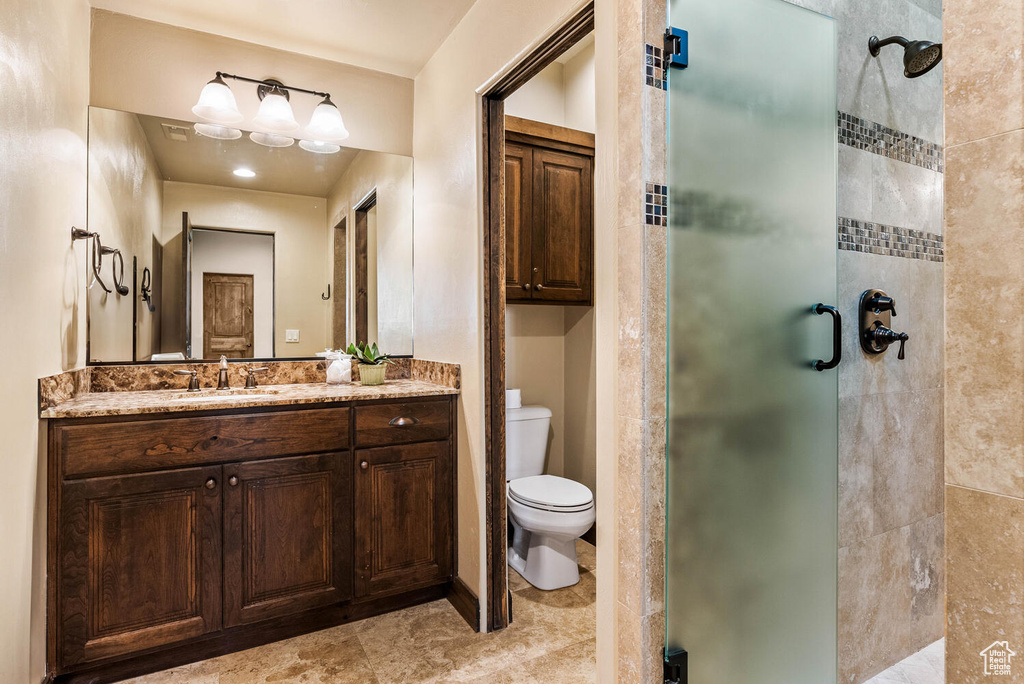 Full bath featuring a stall shower and vanity