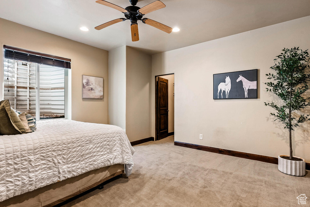 Bedroom with light colored carpet, recessed lighting, and a ceiling fan