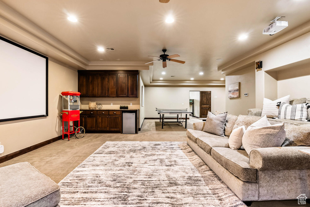 Home theater featuring light carpet, ceiling fan, ornamental molding, and recessed lighting