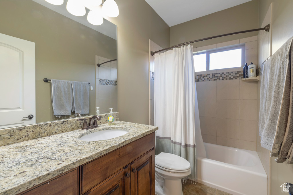 Full bath featuring vanity and shower / bath combination with curtain
