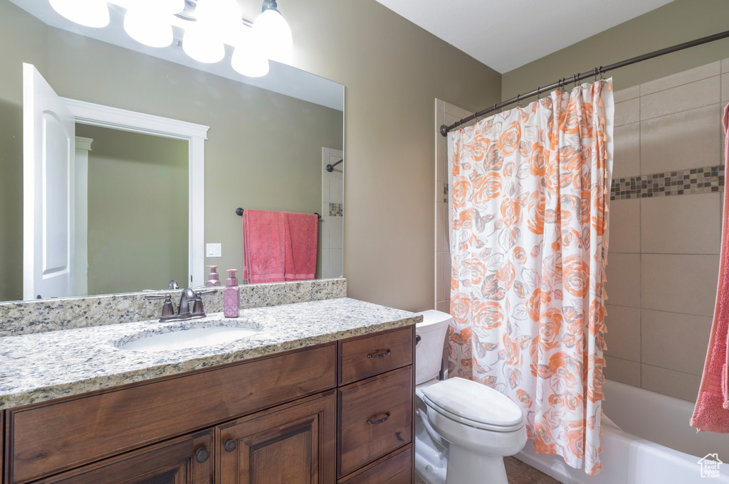 Bathroom with vanity and shower / bath combo with shower curtain