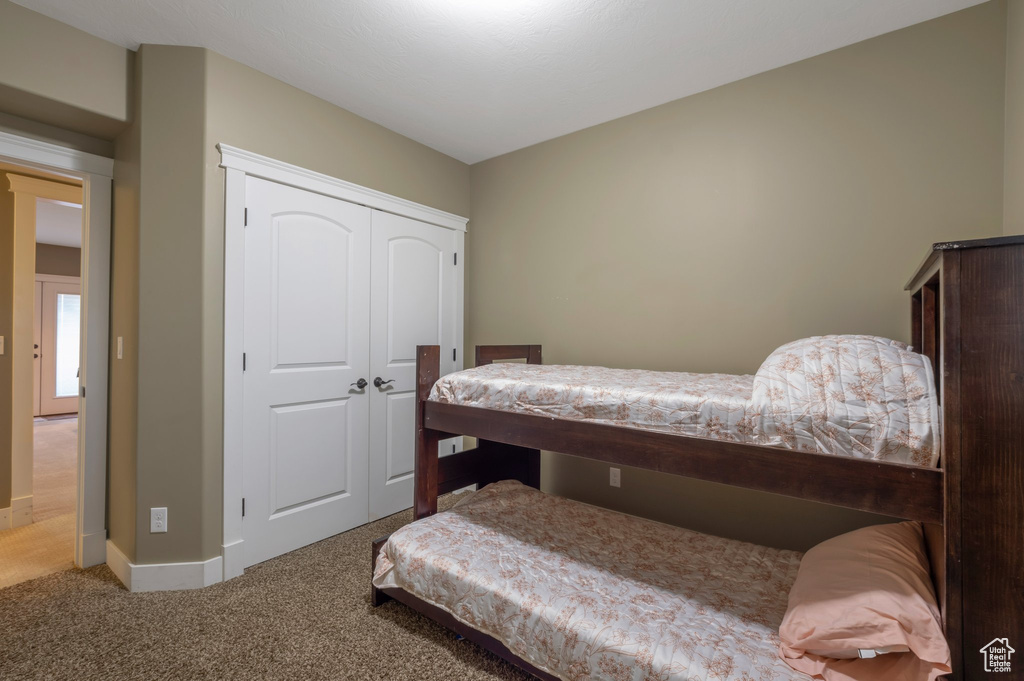Bedroom featuring carpet and a closet