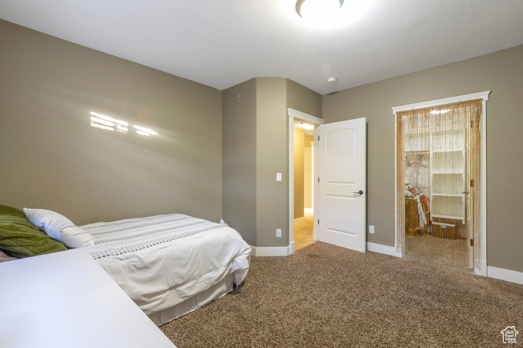 Carpeted bedroom with baseboards