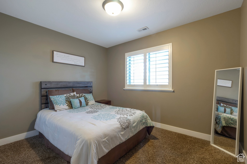 Carpeted bedroom featuring baseboards