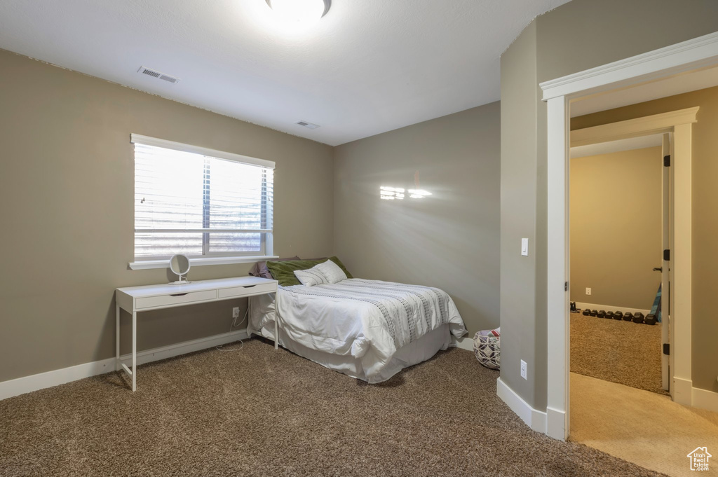 Carpeted bedroom with baseboards