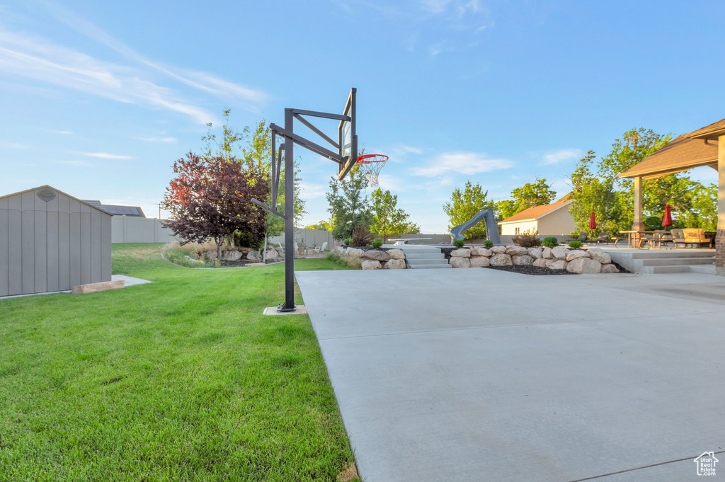 View of yard with a storage shed and a patio area