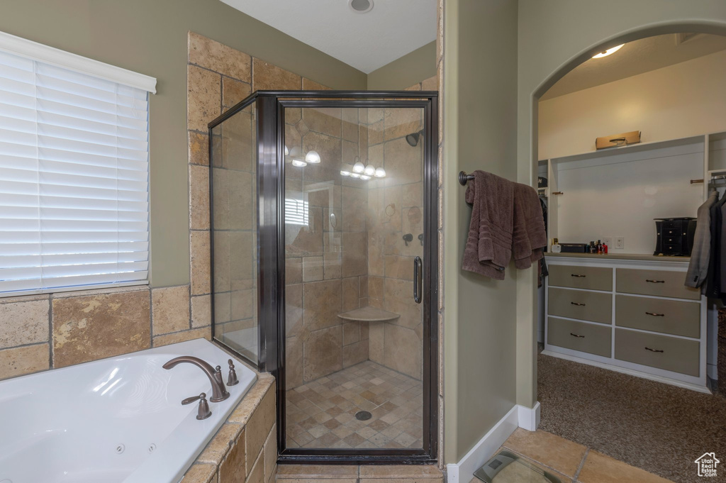 Bathroom featuring a jetted tub, a stall shower, tile patterned floors, and vanity