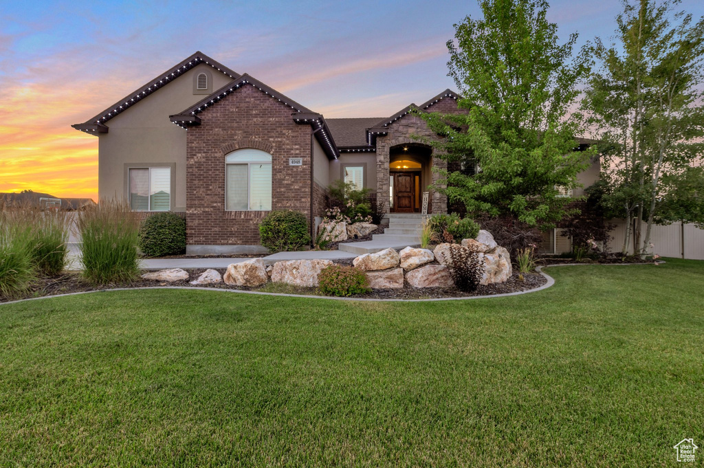 View of front of property with brick siding and stucco siding