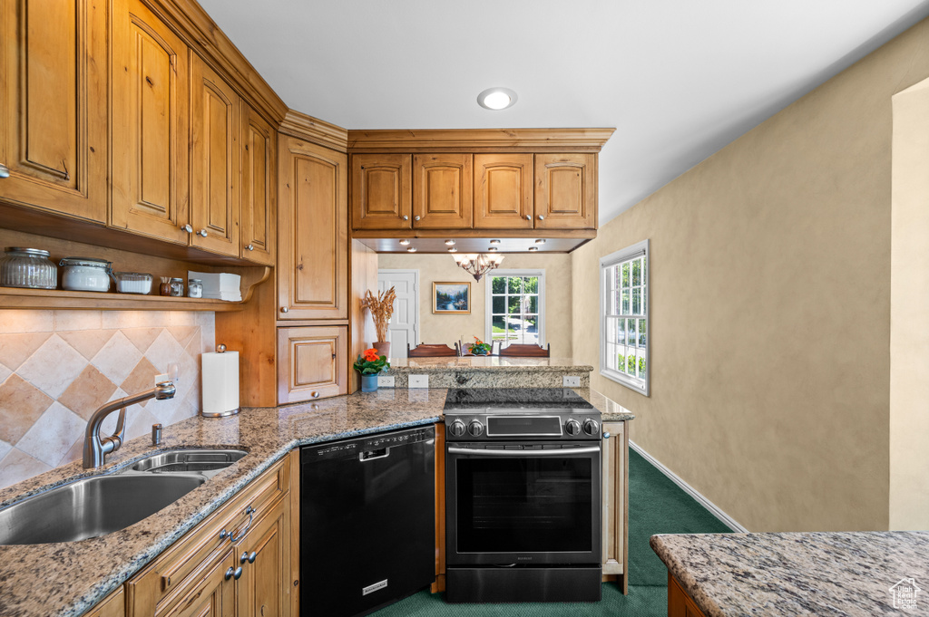 Kitchen featuring black dishwasher, stainless steel electric range oven, backsplash, dark colored carpet, and brown cabinets