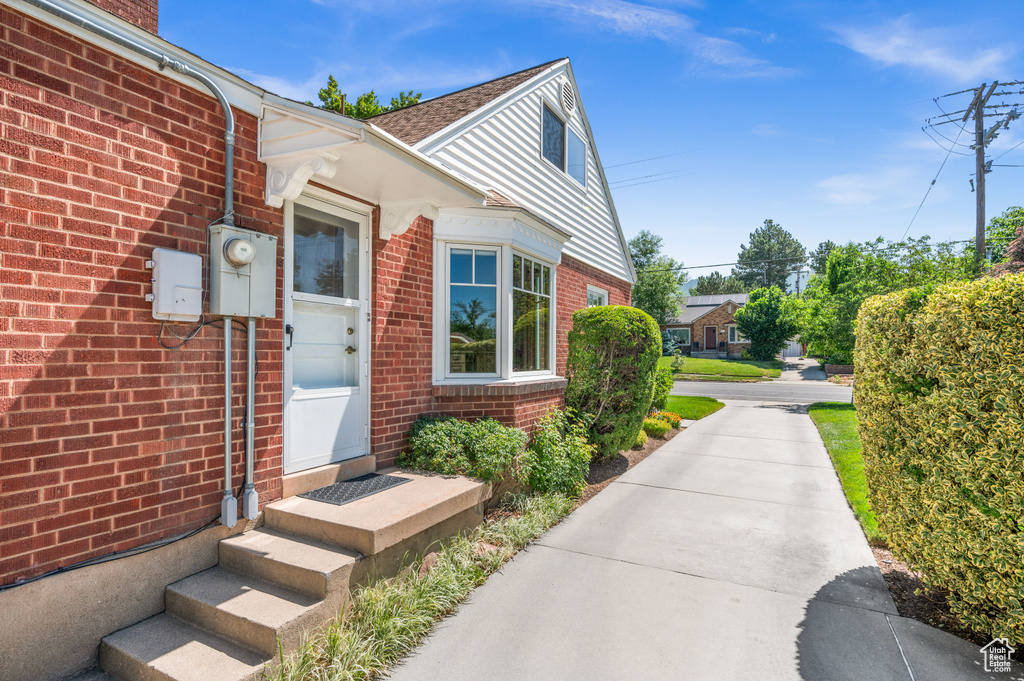 View of exterior entry featuring brick siding