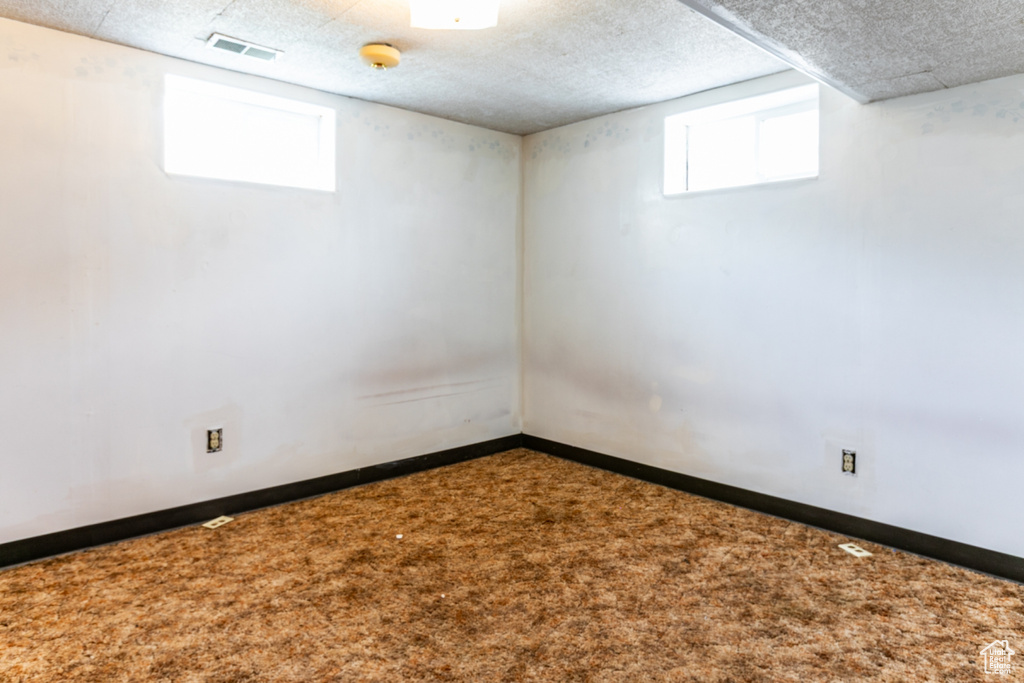 Below grade area with carpet flooring and baseboards