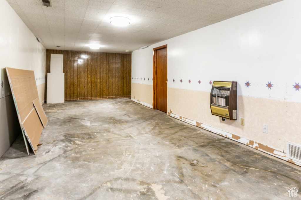 Finished below grade area with heating unit and wood walls